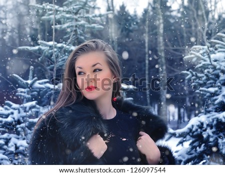 Young woman in winter forest