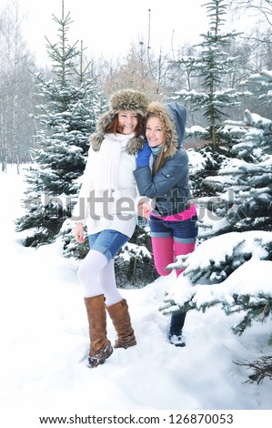 Young beautiful girls are in the winter forest