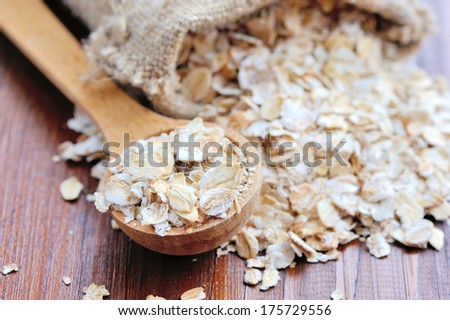 Oat Flakes On Wooden Table