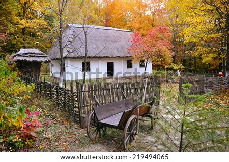 Ukrainian Museum of Life and Architecture. Ancient hut with a straw roof and wooden cart