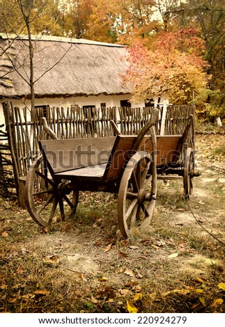 Vintage wooden cart in the yard in the autumn. Ukrainian Museum of Life and Architecture.