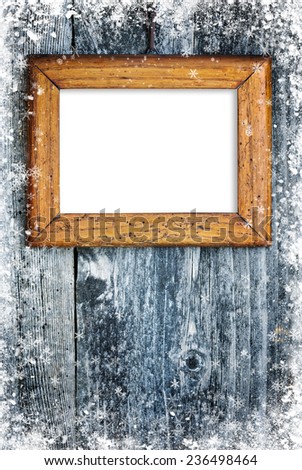 Old frame on snowbound wooden background