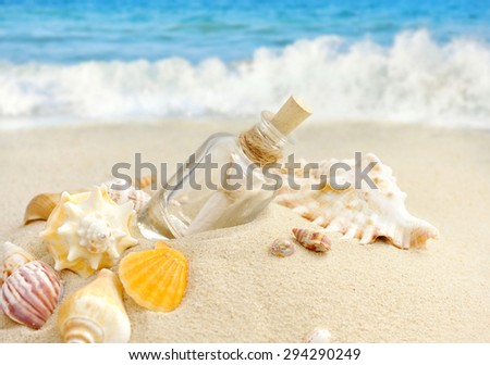 Summer sandy beach concept with letter in bottle