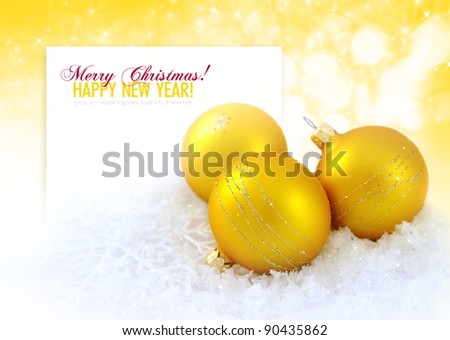 Christmas composition is with gold balls on snow and by a sheet for text