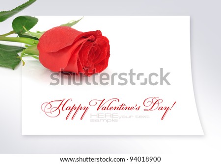 Red rose on the sheet of paper with space for text