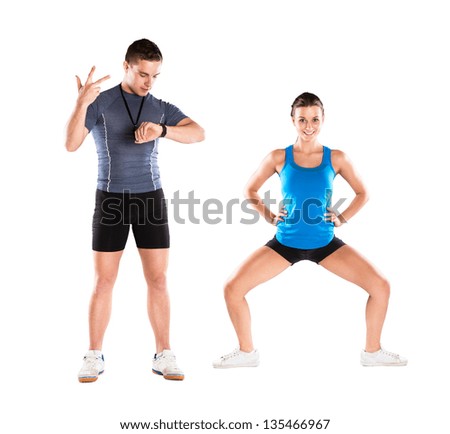 Professional fitness coach with beautiful young woman on white background