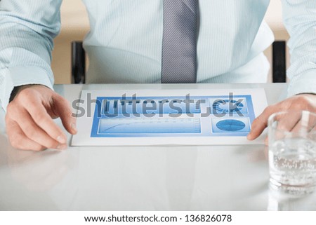 Business people reading business graphs and charts