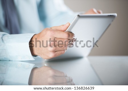 Businessman uses the new media technologies and devices to work successfully