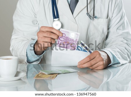 Closeup on medical doctor hands, taking money