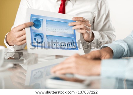 Business people reading business graphs and charts
