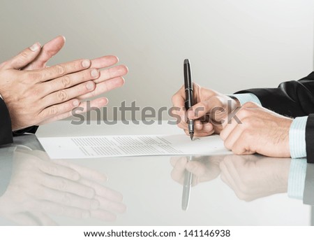 Businessmen are signing a contract, business contract details