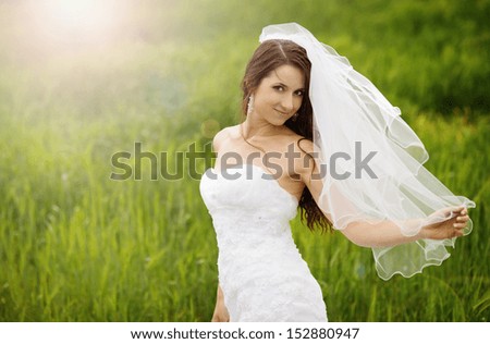Happy bride enjoying her wedding day in nature