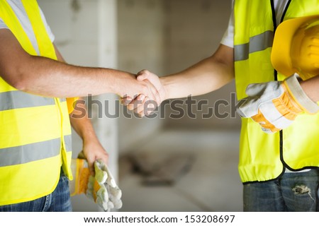 Construction Workers Collaborating On New House Building