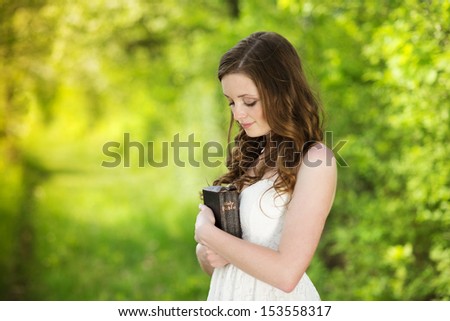 Beautiful Woman With Bible Is In Sunny Nature