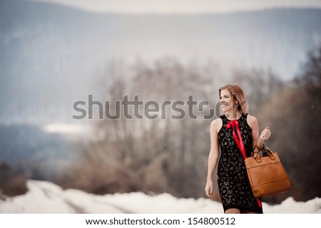 Attractive model in fashion dress in winter country