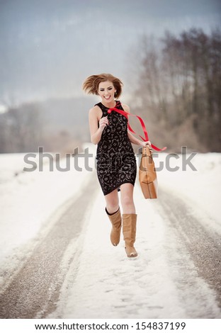Attractive model in fashion dress in winter country
