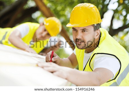 Construction Workers Collaborating On New House Building