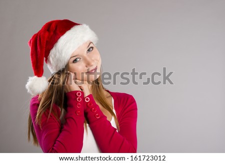 Portrait of attractive woman, studio shot in christmas hat