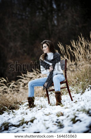 Outdoor portrait of beautiful woman in winter forest