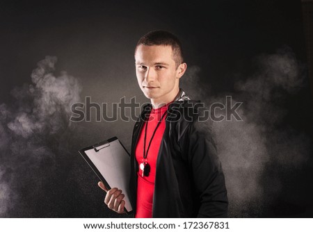 Professional fitness coach isolated on black background