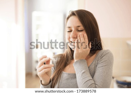 Happy woman with positive pregnancy test result. She is excited at home.