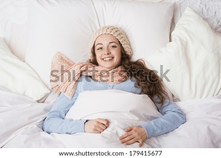 Sick woman lying in bed with high fever. She has cold and flu.