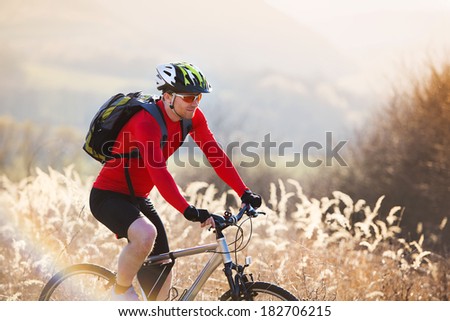 cyclist man riding mountain bike on outdoor trail in nature