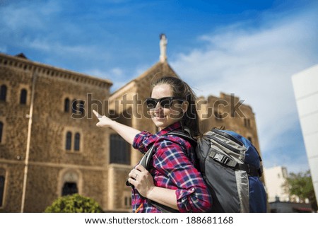 Pretty young female tourist posing in front of the church in Barcelona, Spain.