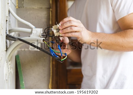 Electrician installing light in a new house