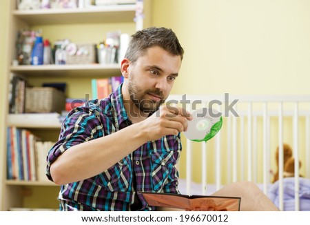 Man holding damaged CD sitting on florr in bedroom