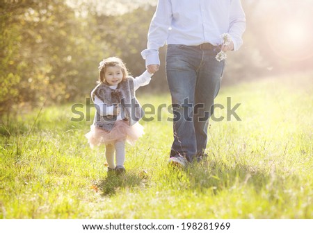 Young father during morning walk with his little daughter