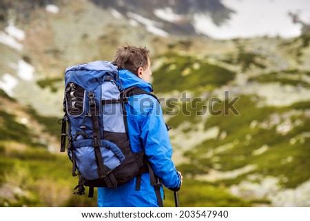 Senior tourist man hiking at the beautiful mountains