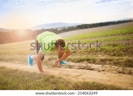Male runner tripping over and falling down on the cross country trail