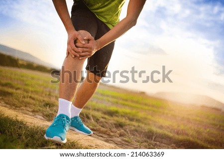 Runner leg and muscle pain during running training outdoors in summer nature