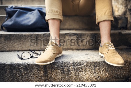 Detail of modern hipster manÃ?ÃÂ´s feet sitting on the stairs
