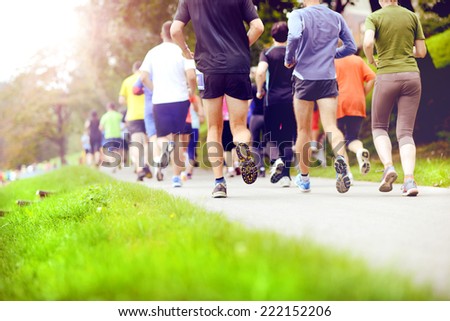 Group of unidentified marathon racers running, detail on legs