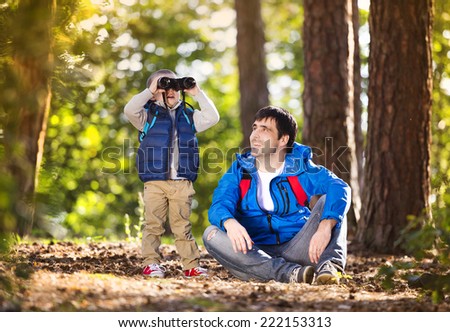 Father and son enjoying a walk in the forest