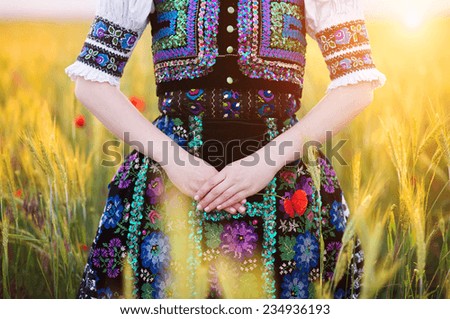 Detail of woman dress. She is wearing traditional Eastern Europe folk costumes.