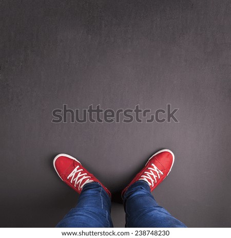 Feet concept with red shoes on black background with blank space for text or symbol