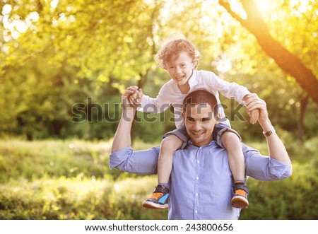 Little boy and his dad enjoying their time together outside in nature