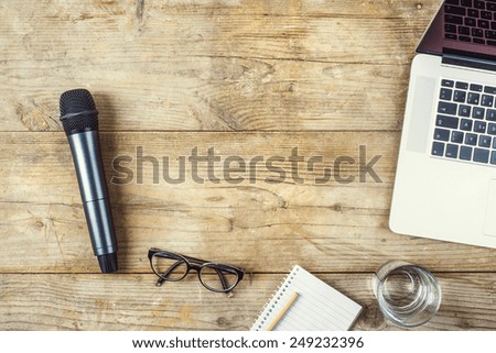 Composition of office gadgets and supplies on a wooden desk background. View from above.