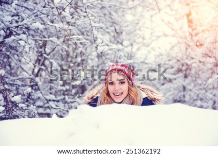Attractive young woman having fun outside in snow