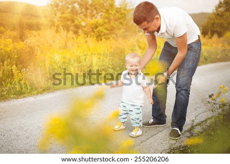Father and son on a walk in nature enjoying life together.