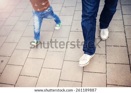 Cute little boy and his father on a walk in the city