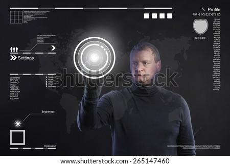 Thief in action stealing information with balaclava on his face, dressed in black. Studio shot on black background.
