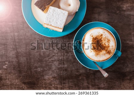 Coffee and cakes on a wooden table background