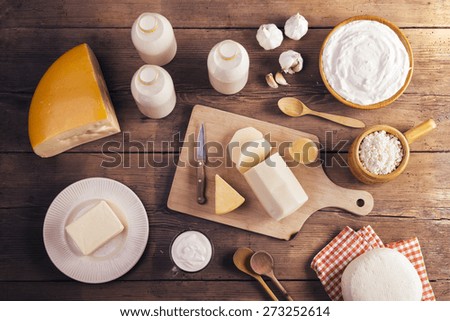 Variety of dairy products laid on a wooden table background