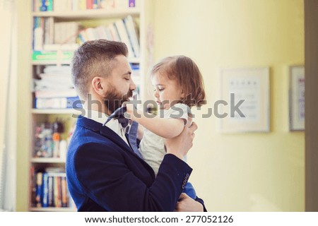 Young father hugging his daughter as he gets home from work