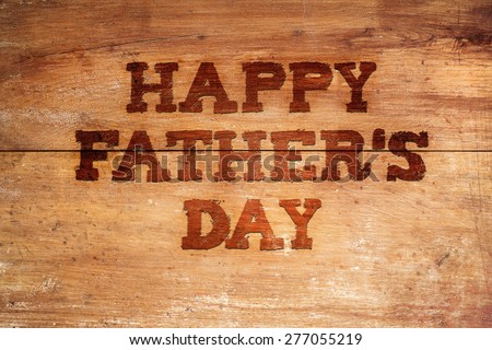 Happy fathers day sign on wooden boards background.