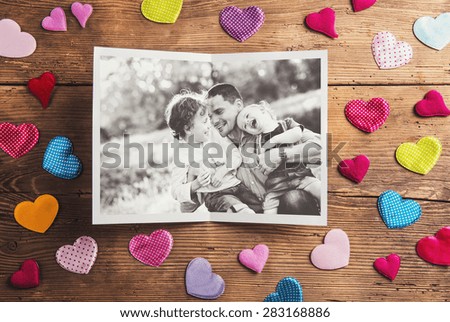 Fathers day composition - textile hearts on the floor. Studio shot on wooden background.